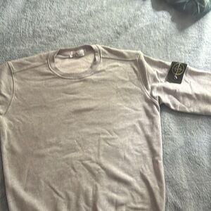 A grey stone island hoodie